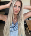 Woman wearing a long wig in color "Julianne Hough"